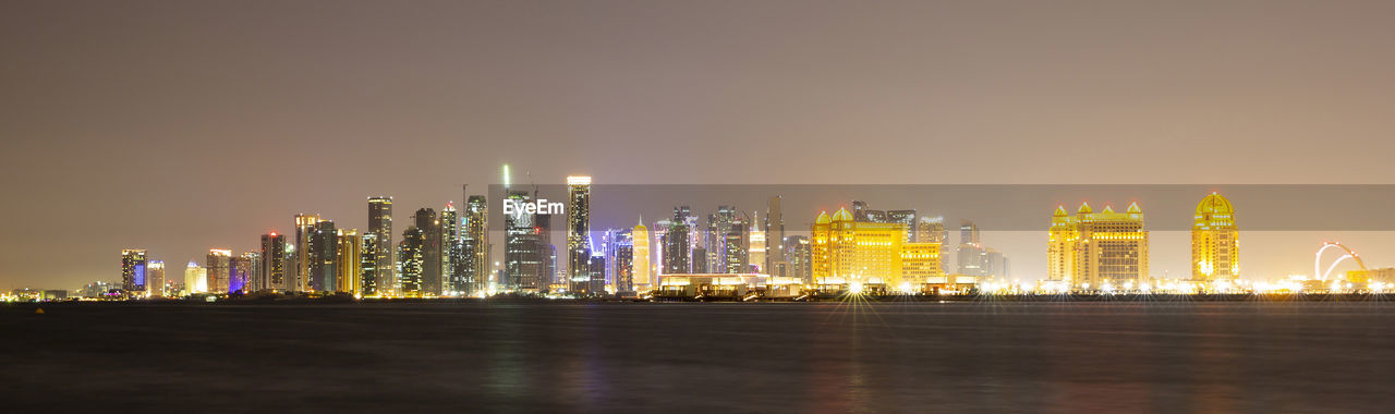ILLUMINATED CITY BUILDINGS AT NIGHT