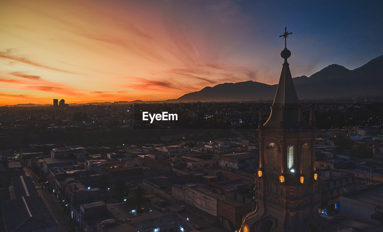 Aerial drone view of arequipa main square and cathedral church, with the misti volcano at sunset. 