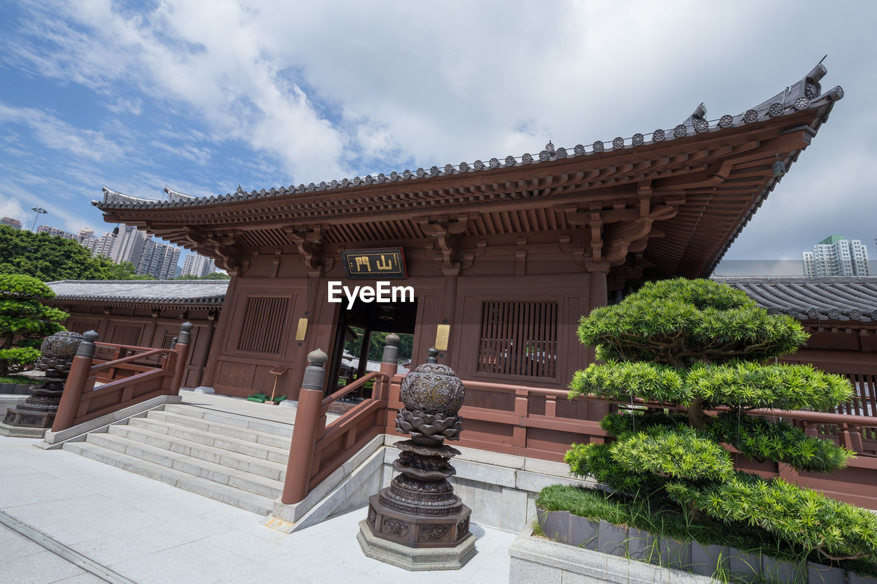 EXTERIOR OF TEMPLE AGAINST BUILDING AND SKY