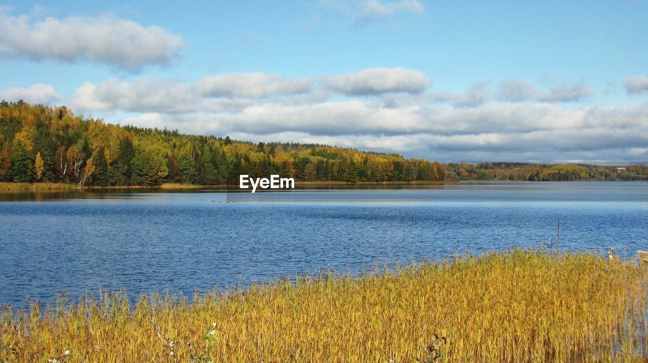 Scenic view of lake against cloudy sky