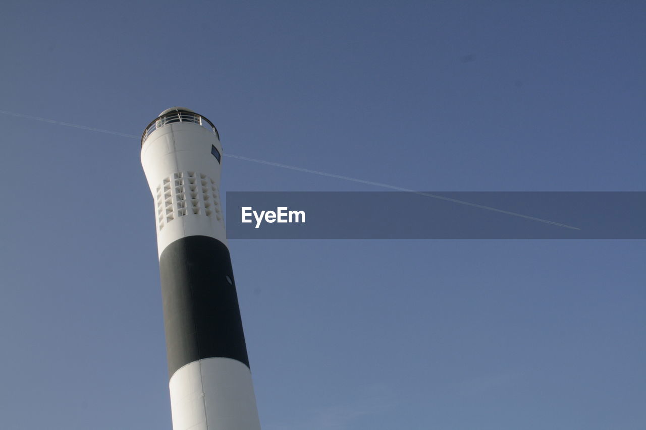 LOW ANGLE VIEW OF TOWER AGAINST BLUE SKY AND CLEAR BACKGROUND