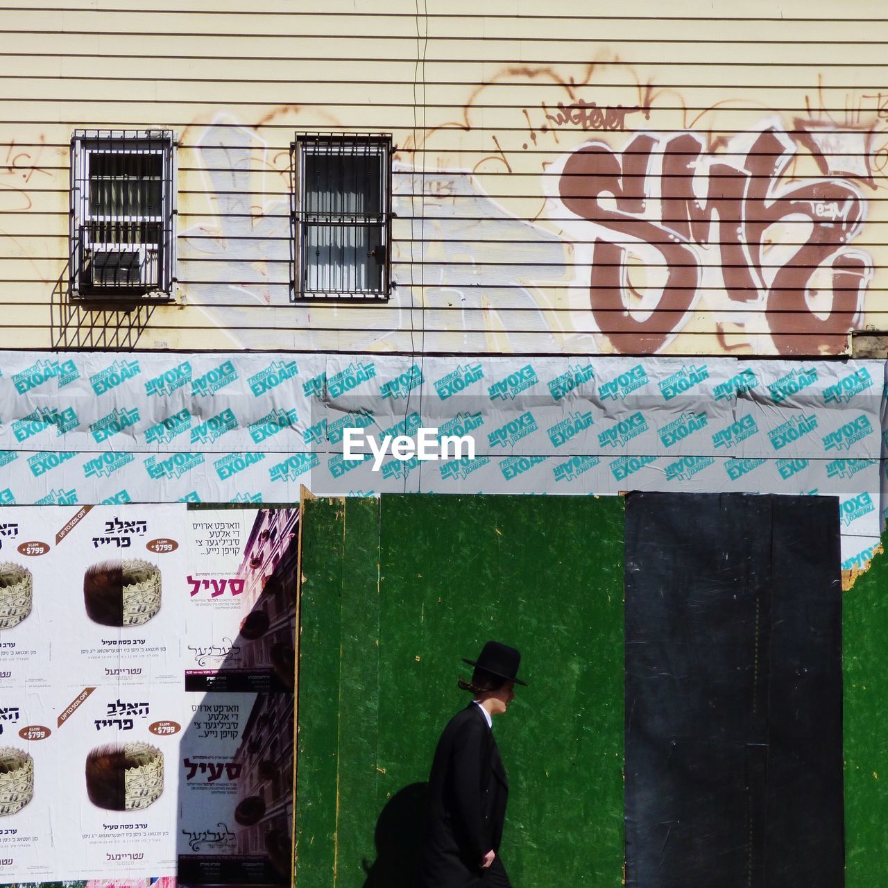 WOMAN STANDING ON WALL