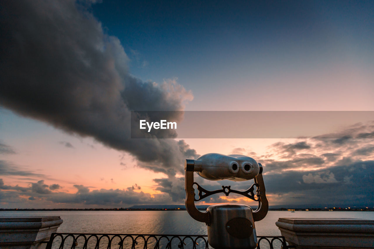 Panoramic sea binoculars with spectacular sunset in the background