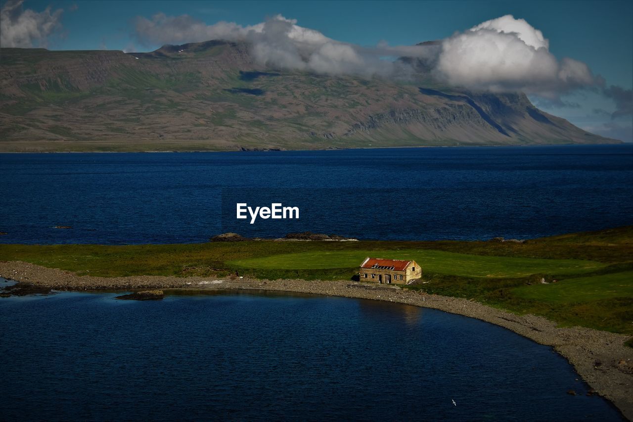 Scenic view of sea by mountain