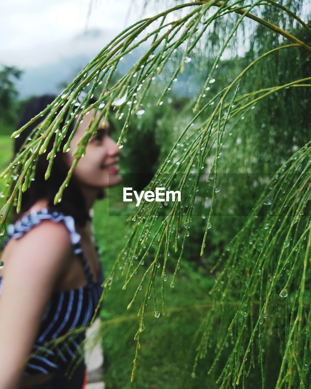 Side view of woman on wet land