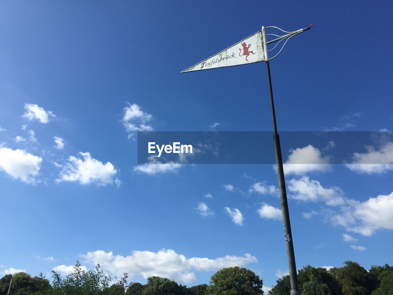 LOW ANGLE VIEW OF FLAGS AGAINST SKY