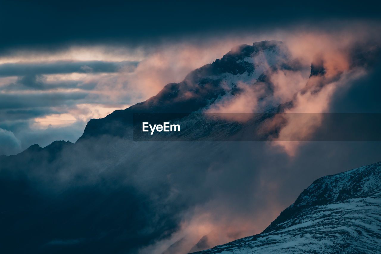 low angle view of snowcapped mountains against sky
