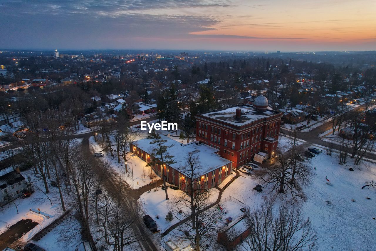 Drone photo of building in winter at dusk