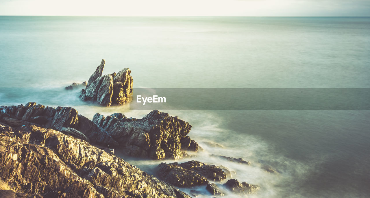 Scenic view of sea against cloudy sky