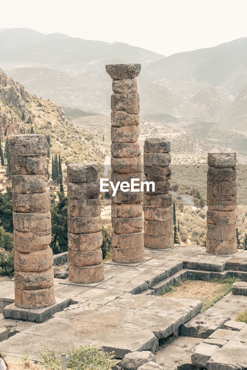 history, architecture, the past, ancient, ruins, old ruin, historic site, ancient history, travel destinations, archaeological site, built structure, travel, ancient civilization, landmark, nature, no people, mountain, monument, archaeology, stone material, rock, tourism, old, temple - building, temple, outdoors, architectural column, landscape, day, environment, column, city, ruined, sky, land, building exterior, building, religion, scenics - nature, wall, fortification