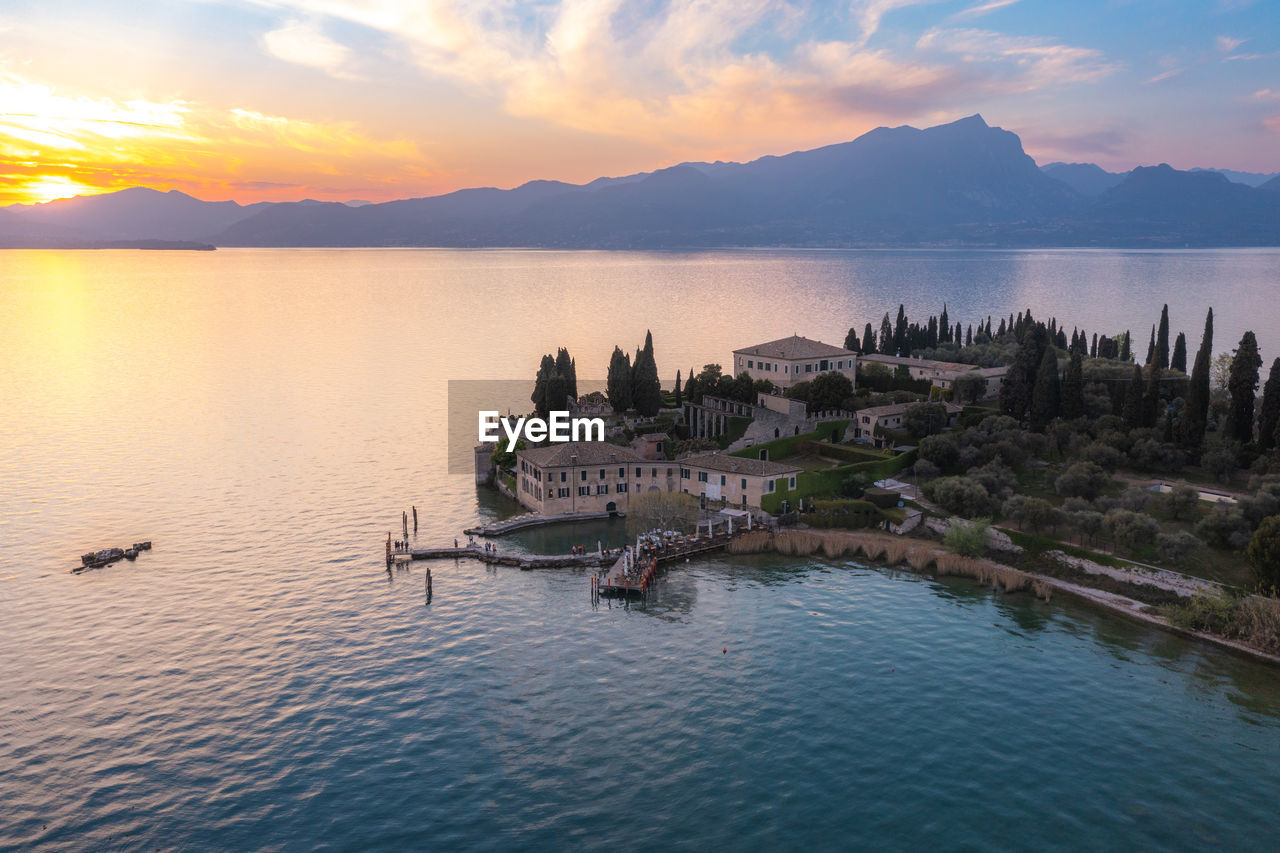 scenic view of lake against romantic sky during sunset