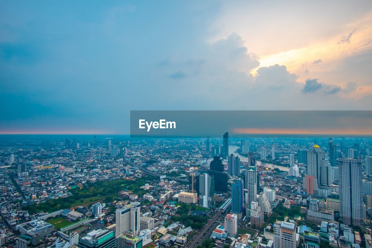 HIGH ANGLE VIEW OF MODERN CITY BUILDINGS AGAINST SKY