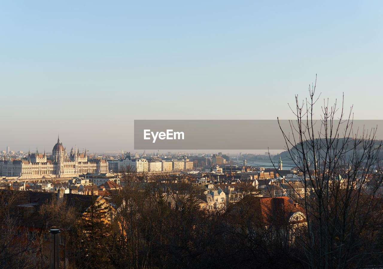 HIGH ANGLE VIEW OF BUILDINGS AGAINST CLEAR SKY