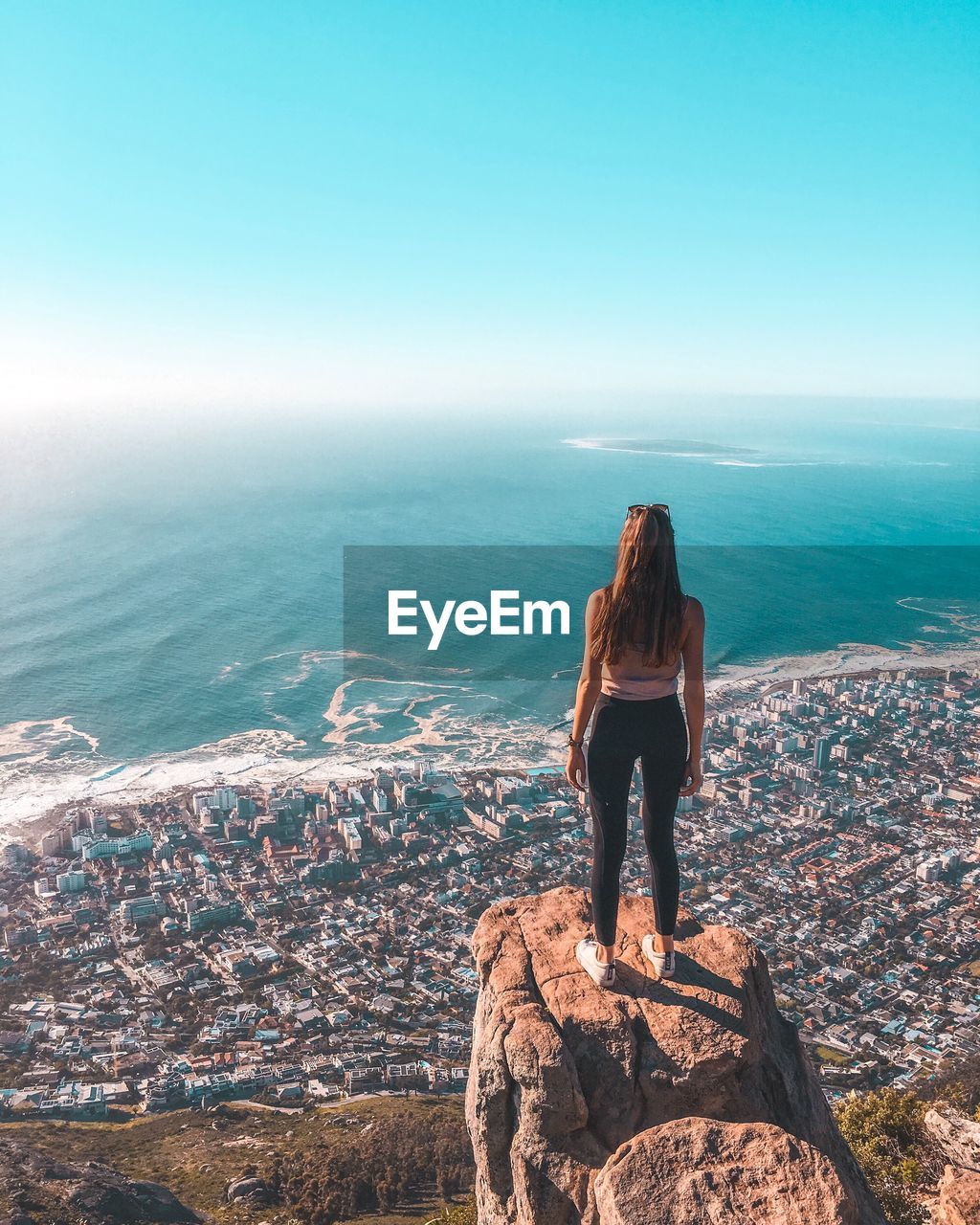 Rear view of woman looking at sea against sky