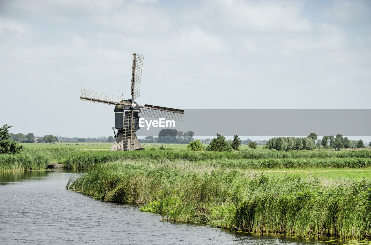 Dutch polder canal with windmill