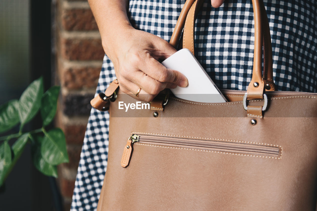 Midsection of woman with purse