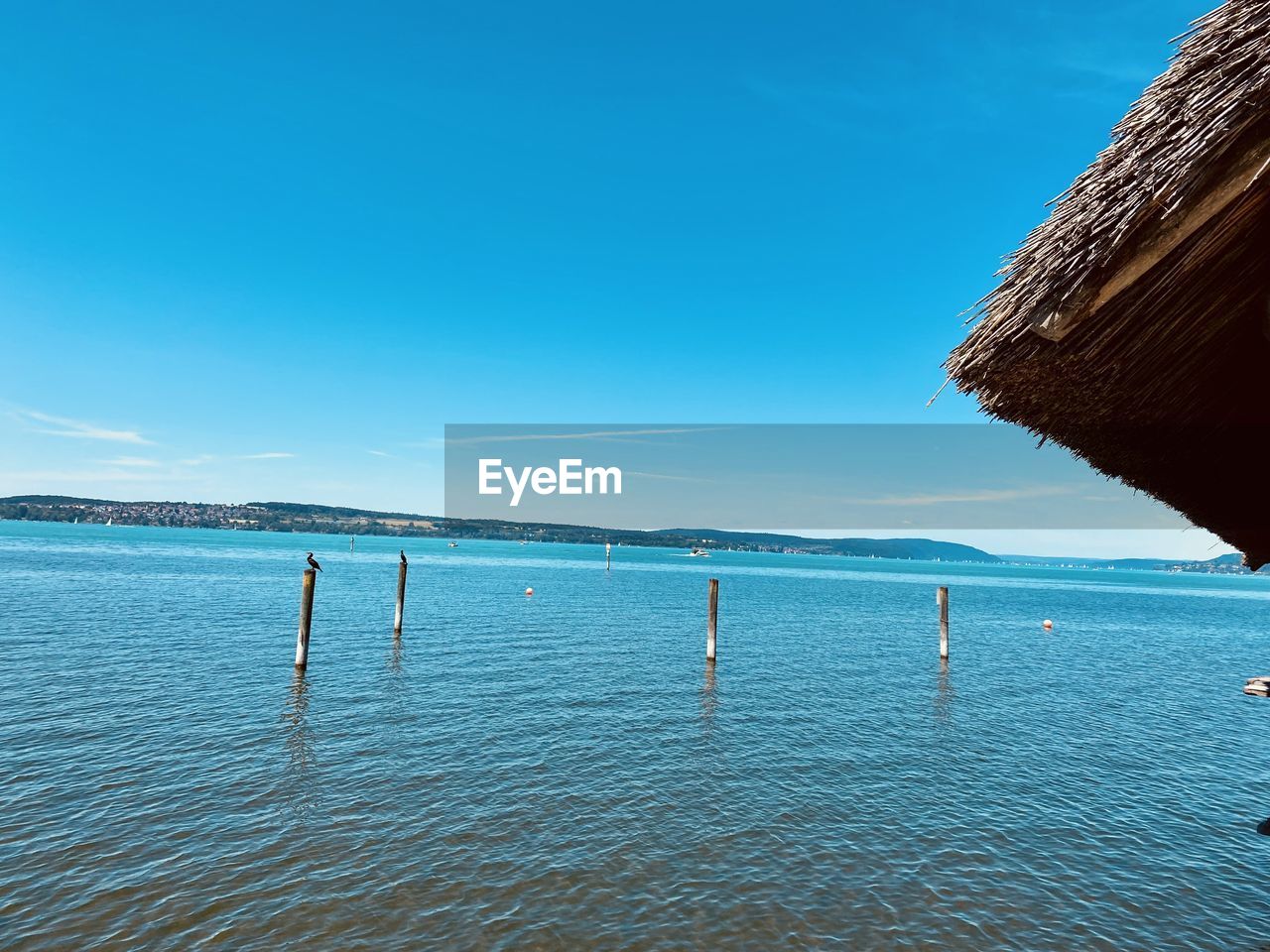 water, sea, sky, ocean, horizon, blue, nature, shore, beauty in nature, scenics - nature, body of water, land, coast, beach, tranquility, day, tranquil scene, bay, clear sky, travel destinations, travel, vacation, no people, reflection, wave, outdoors, holiday, trip, idyllic, sunlight, nautical vessel, horizon over water, non-urban scene, sand, copy space