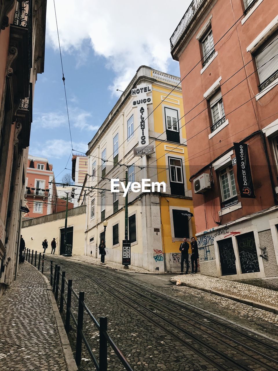 Street amidst buildings in city against sky