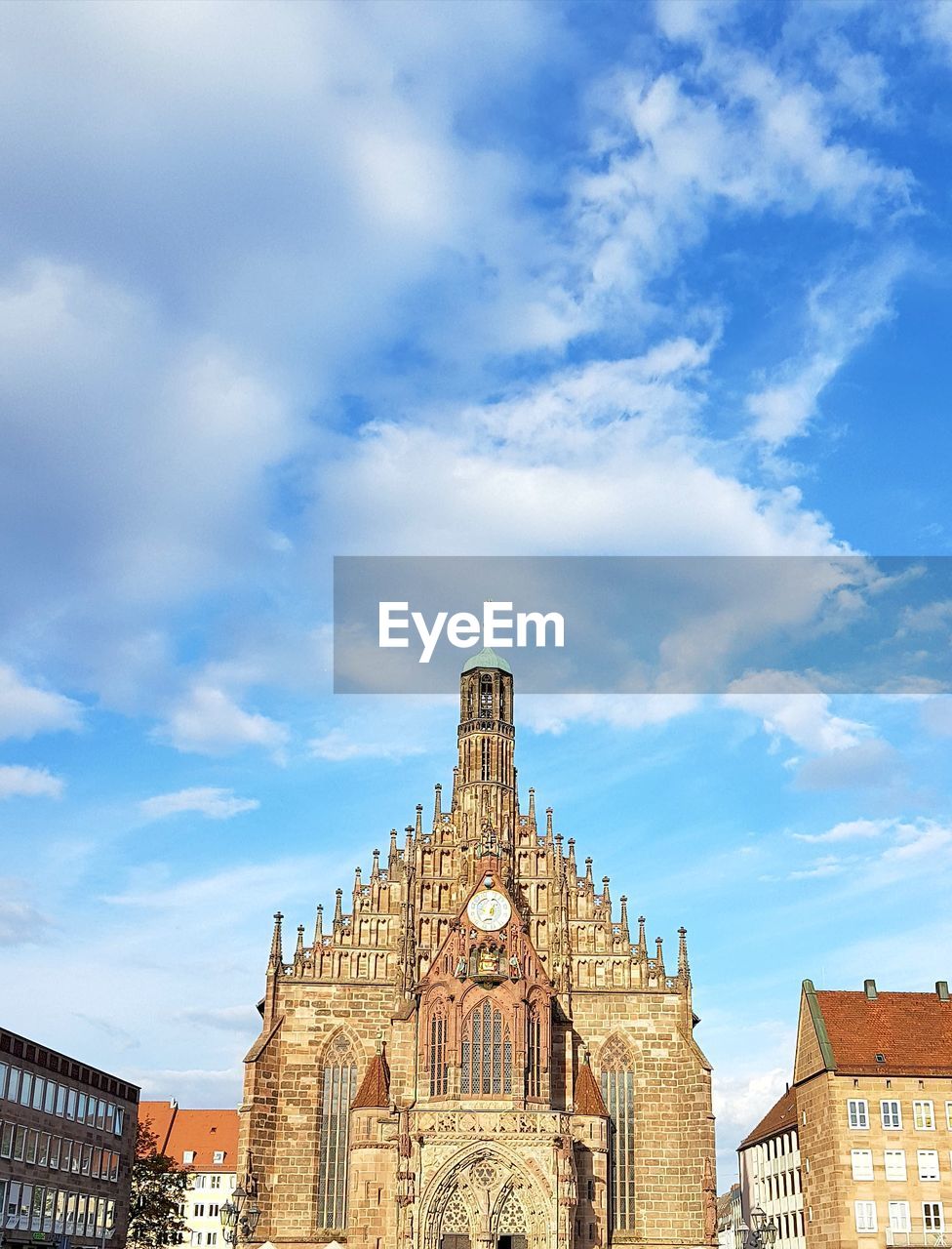 Low angle view of church against cloudy sky