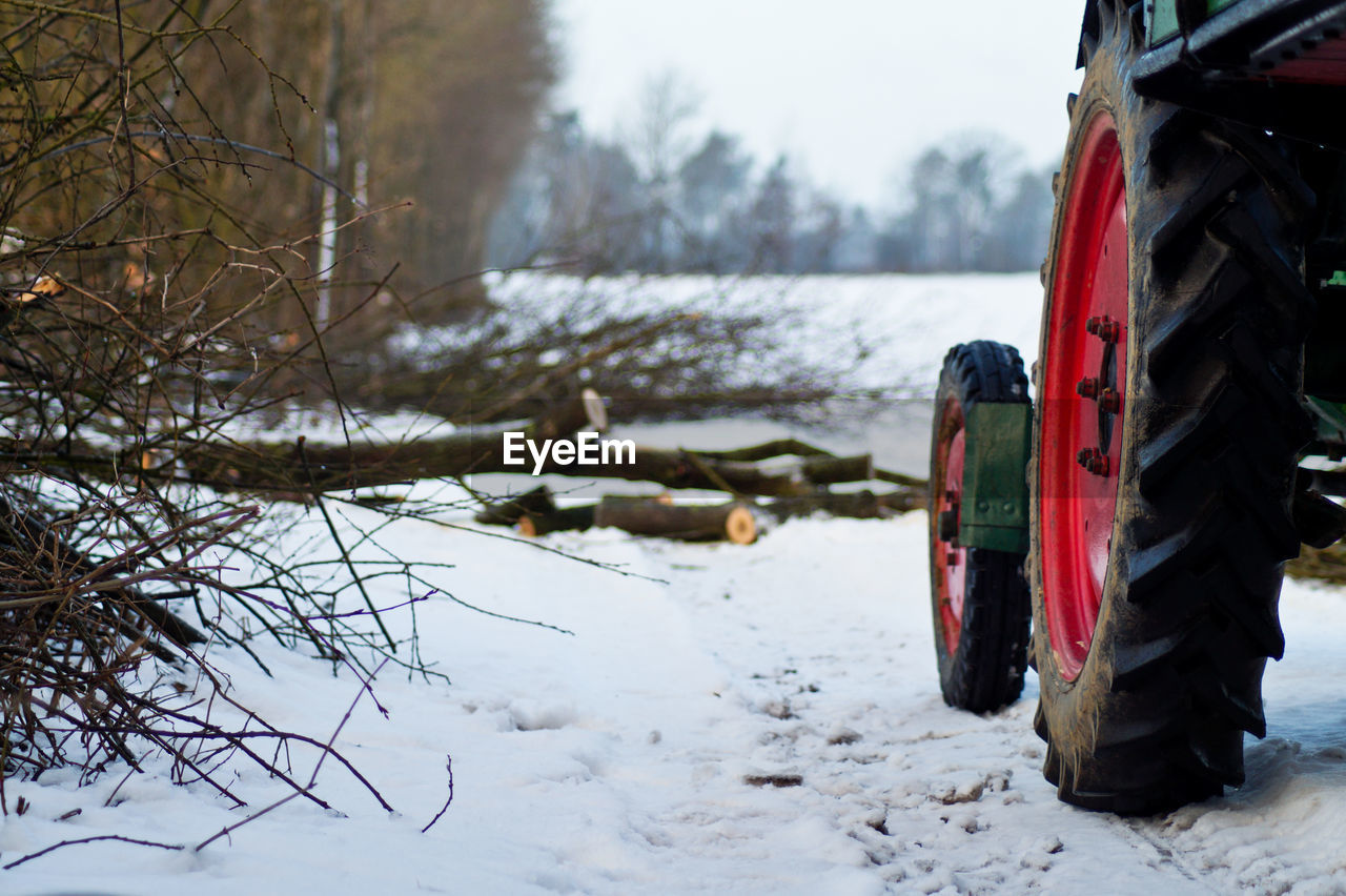 Tractor parked on snow covered field during winter