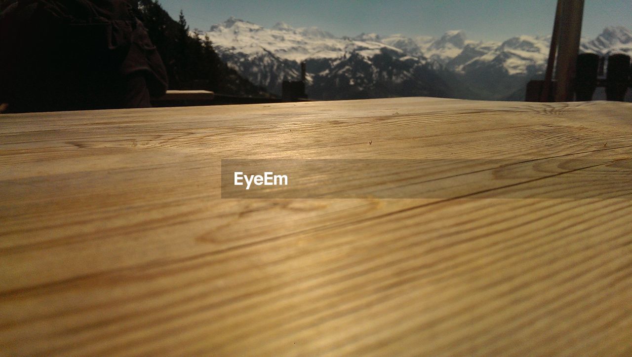 Wooden observation point against snowcapped mountains