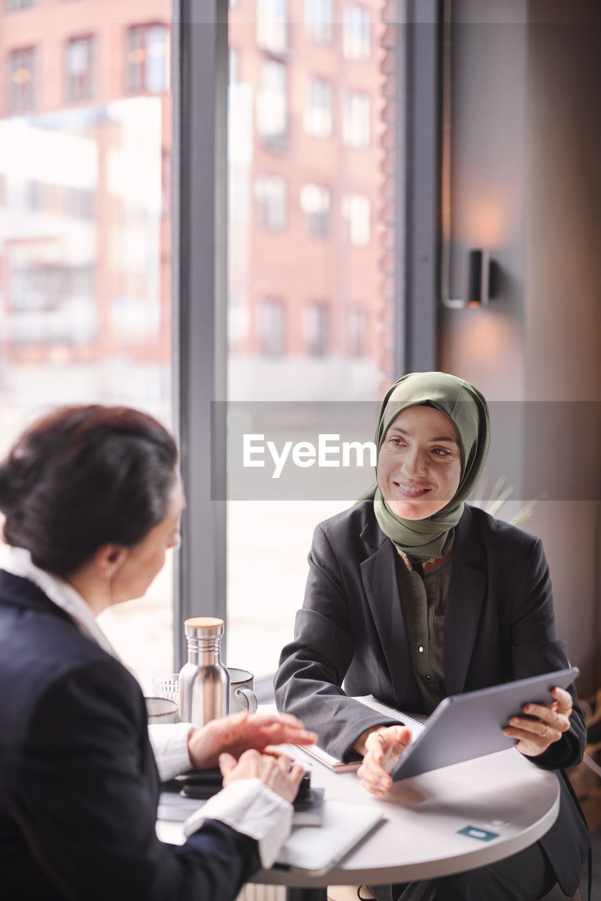 Two businesswomen sitting in cafe