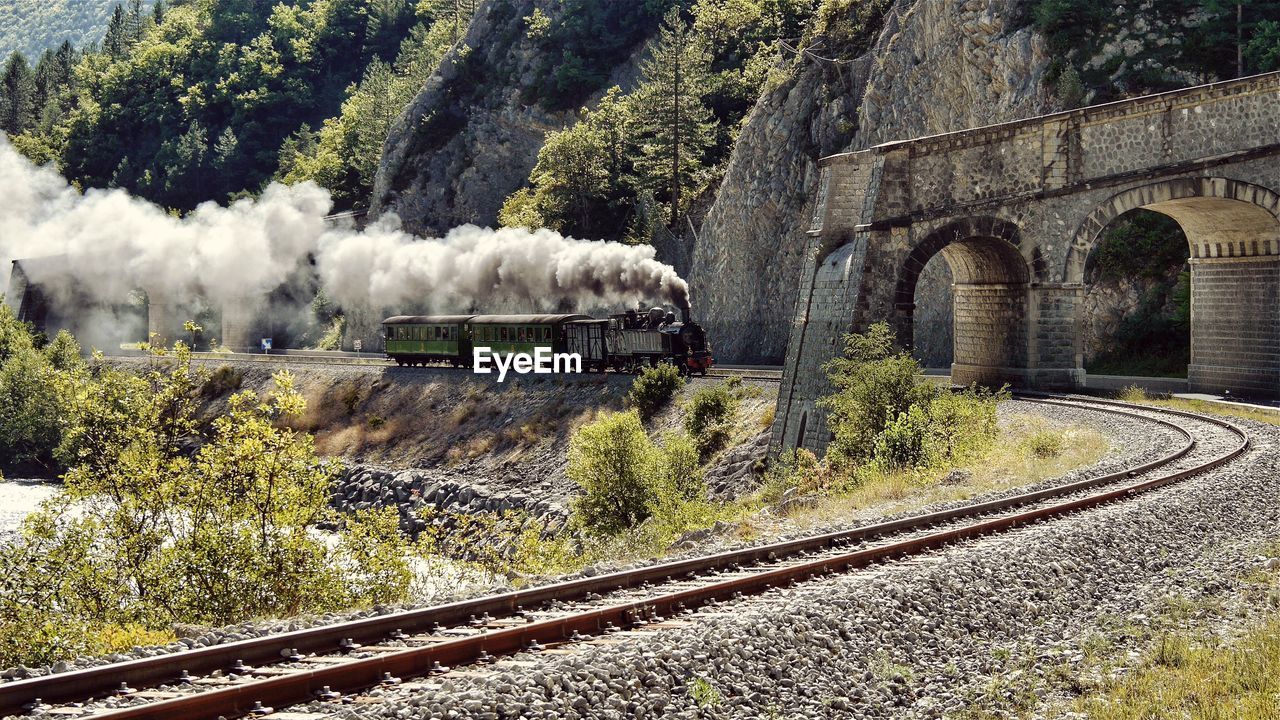 Smoke emitting from engine train on sunny day