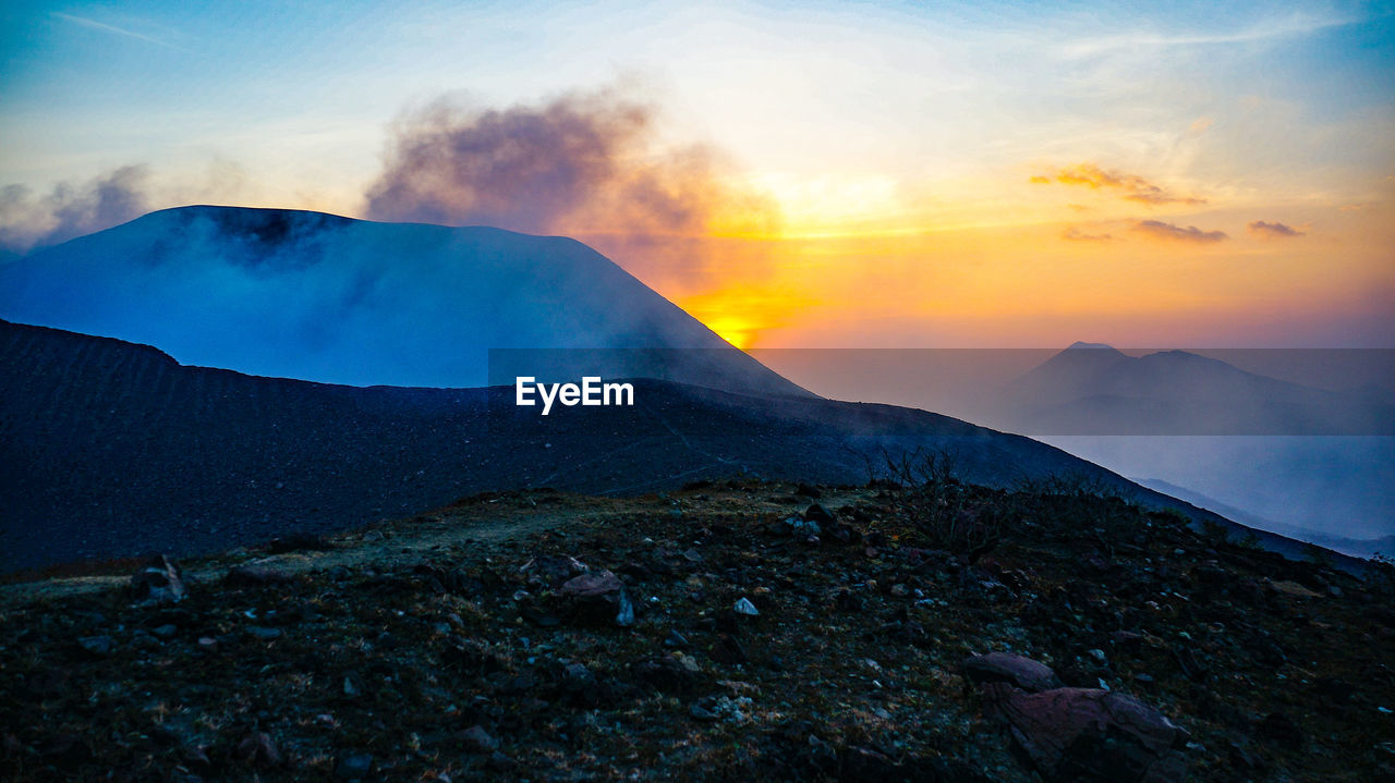 SCENIC VIEW OF MOUNTAINS AGAINST SKY DURING SUNSET