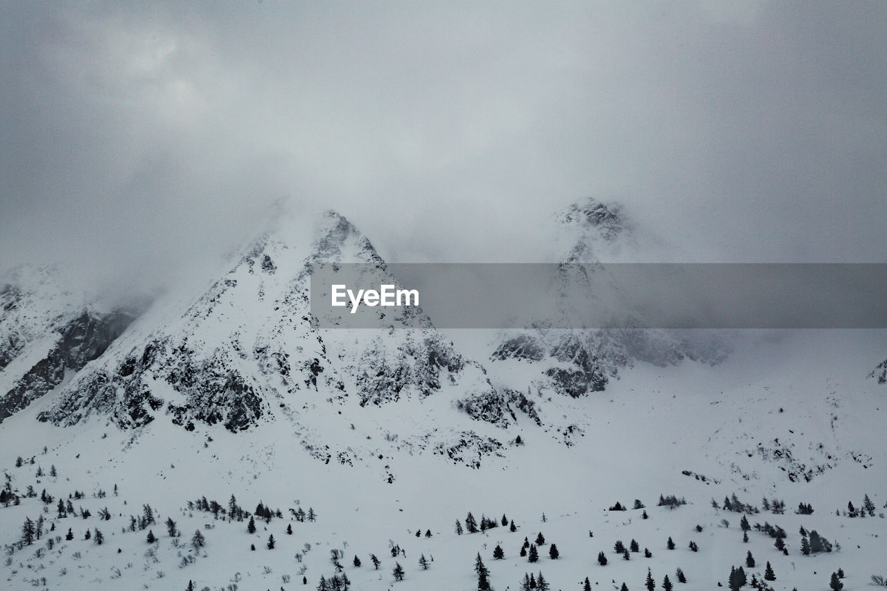 Scenic view of snow covered mountains against sky