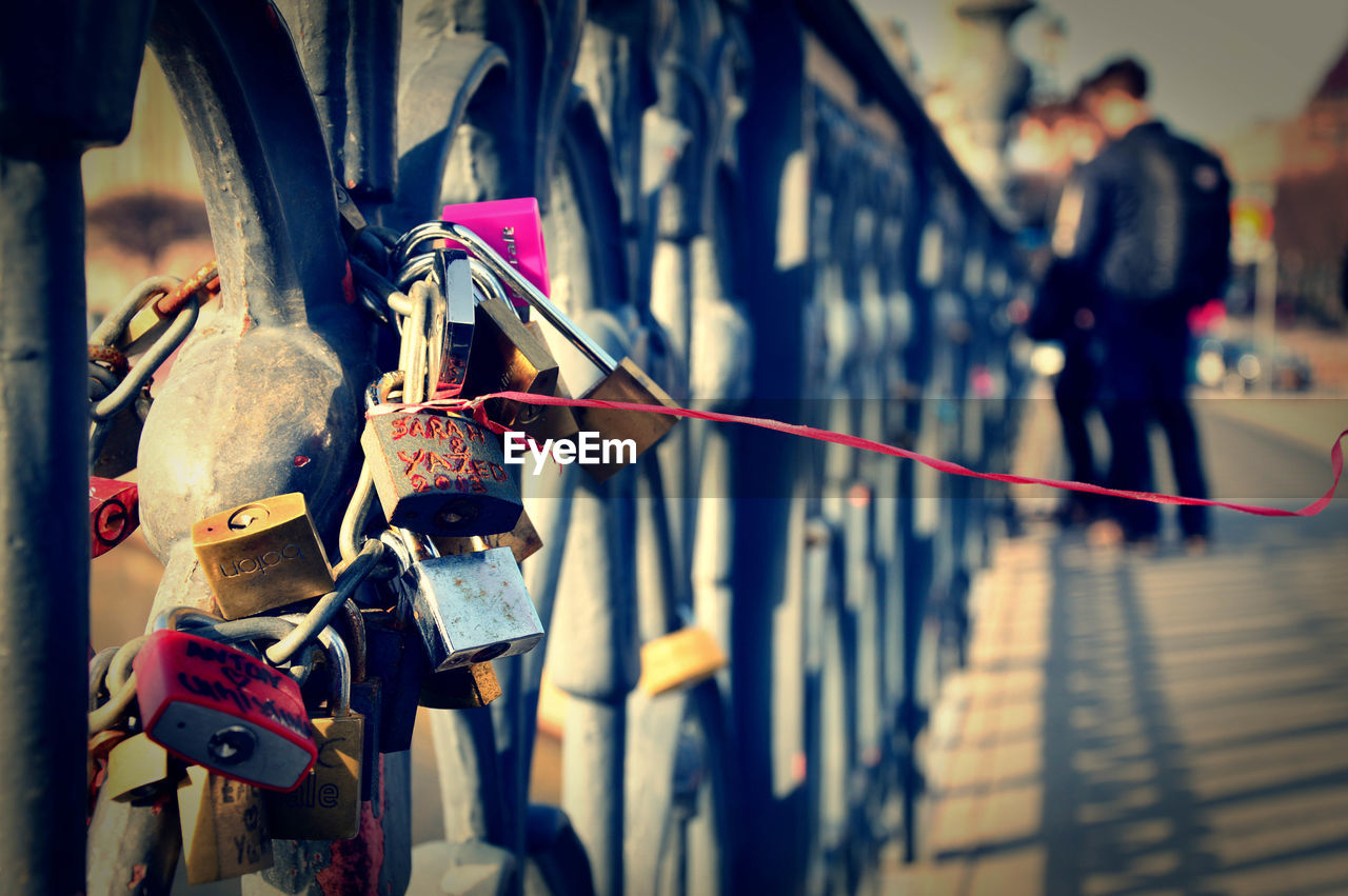 Close-up of padlocks on railing