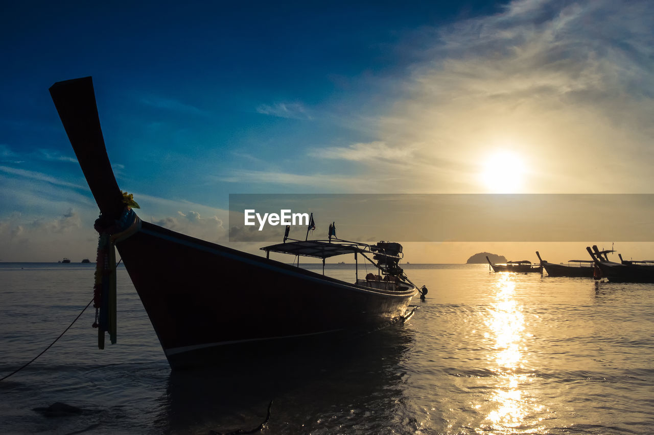 FISHING BOAT MOORED IN SEA AGAINST SKY DURING SUNSET