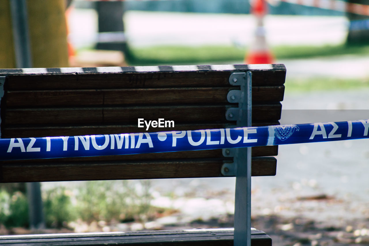 CLOSE-UP OF INFORMATION SIGN ON WOOD