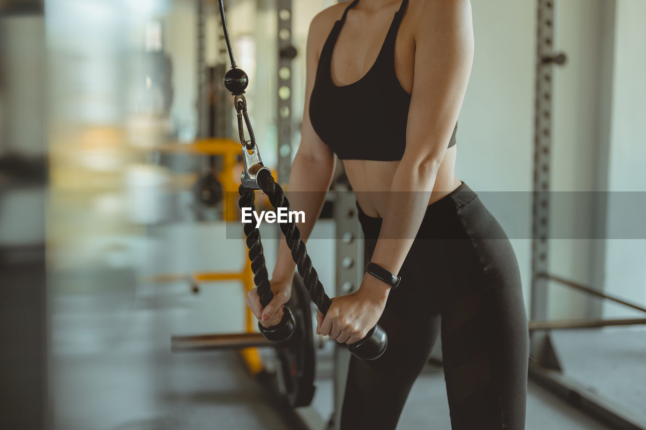 Midsection of woman exercising in gym