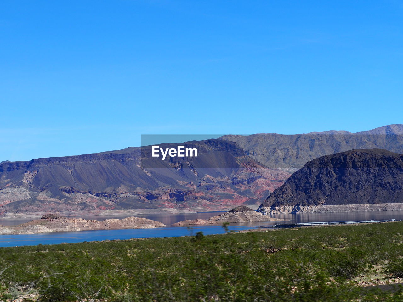 Scenic view of mountain against blue sky