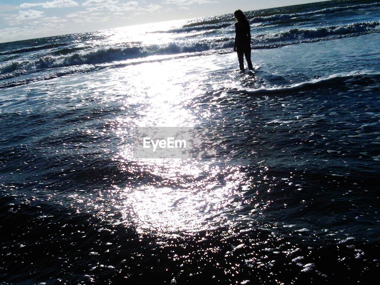 Silhouette woman walking on beach