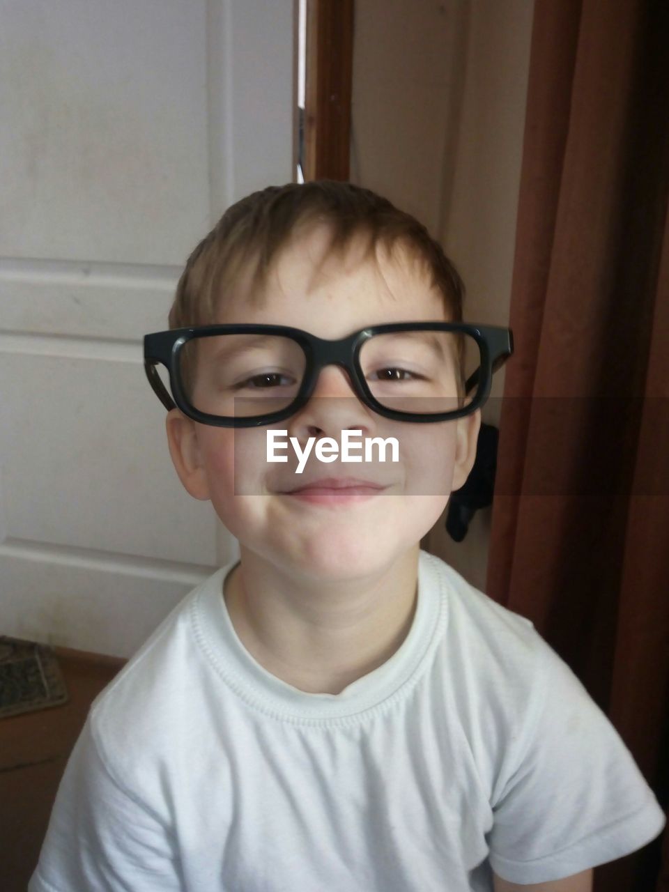 High angle portrait of boy wearing eyeglasses at home