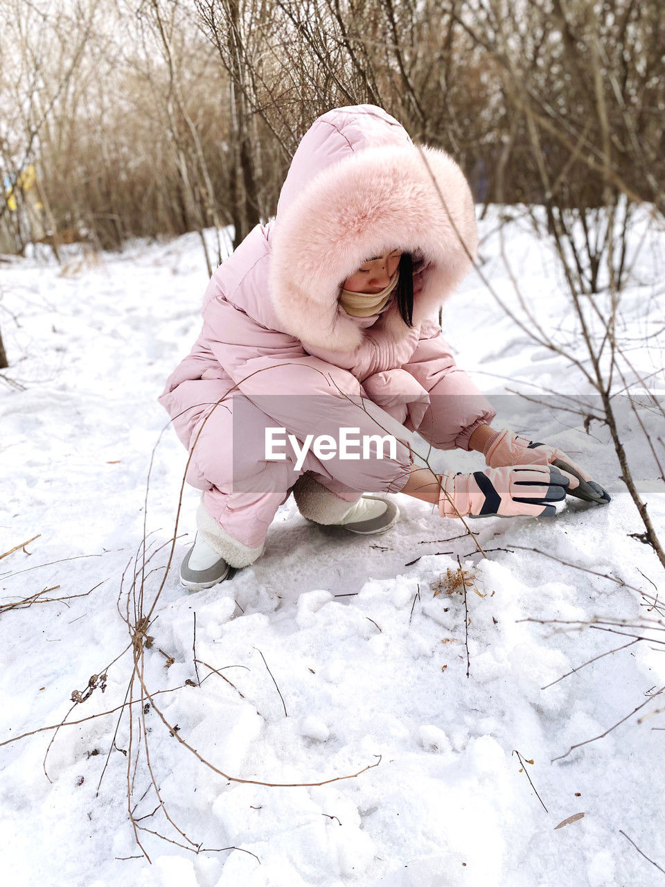 winter, childhood, child, cold temperature, snow, clothing, toddler, baby, one person, nature, full length, tree, spring, warm clothing, footwear, day, female, emotion, cute, pink, land, sitting, innocence, outdoors, plant, hat, women, person, lifestyles