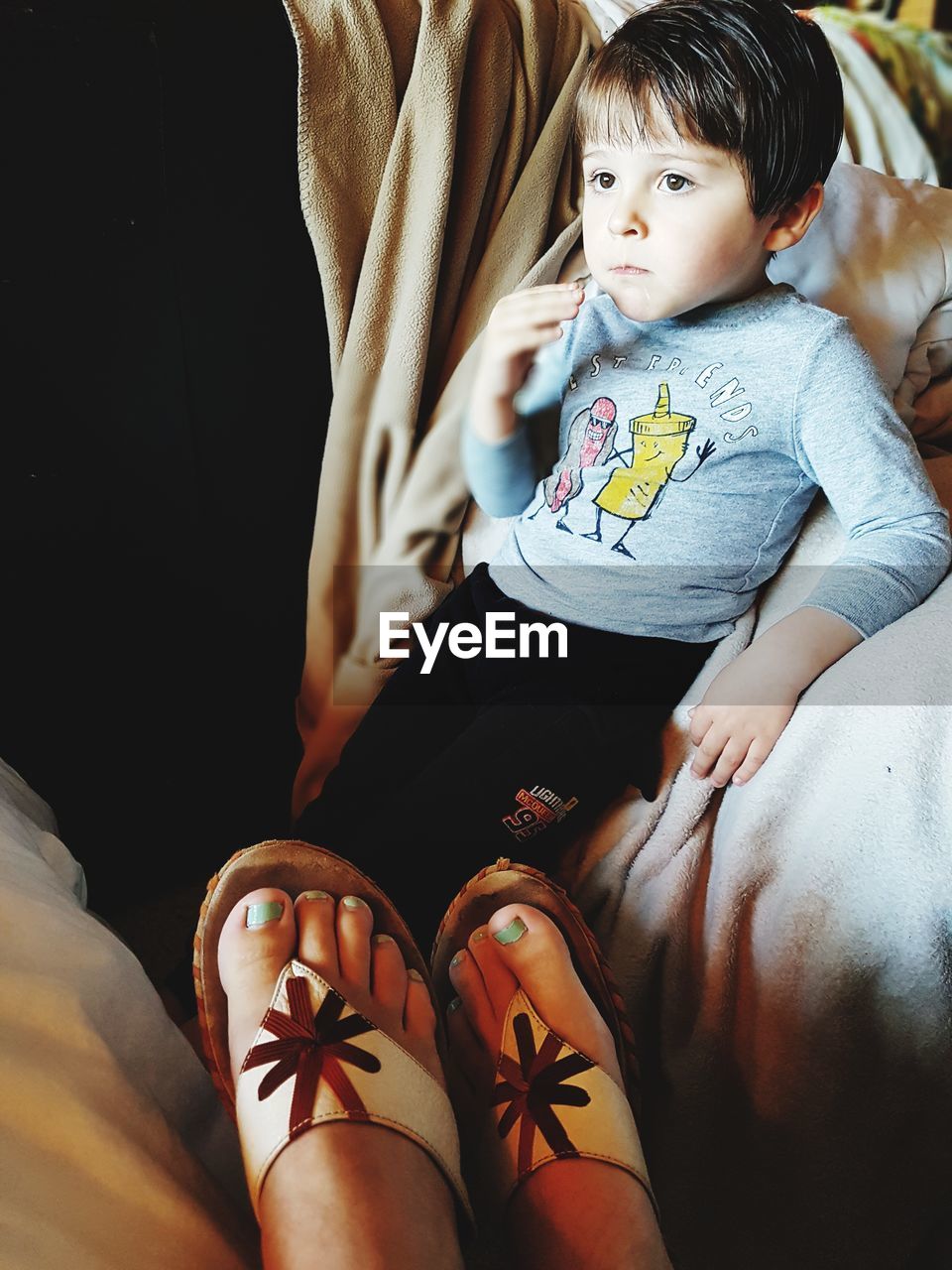 Low section of mother by son at home