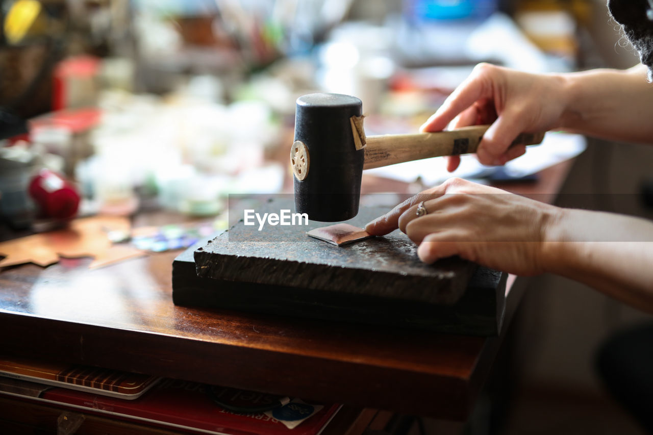 Cropped hand of person working on table