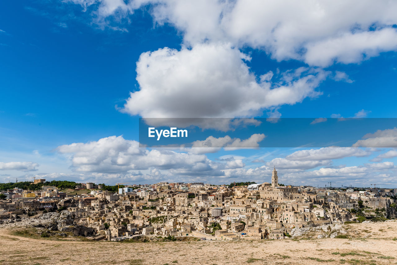 View of sassi di matera against cloudy sky