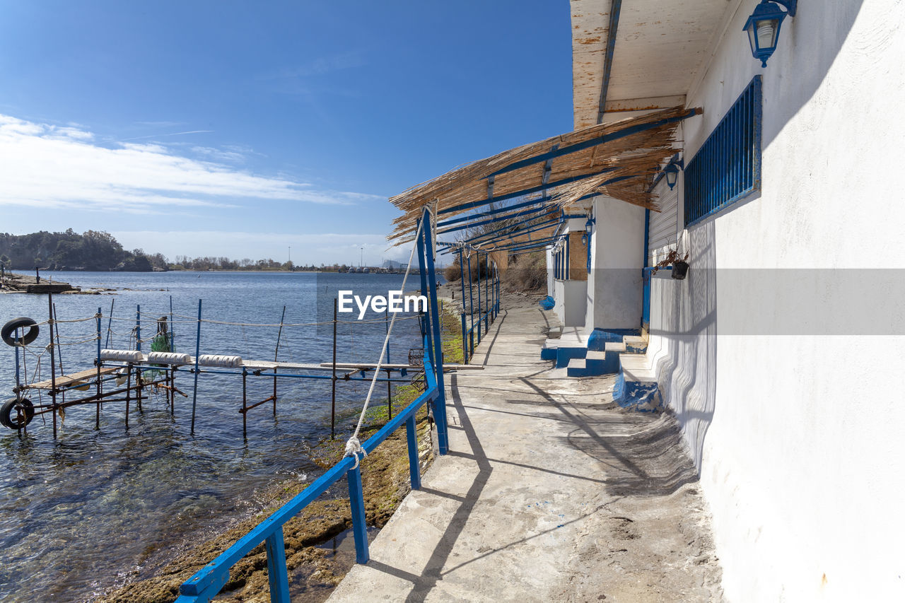 SCENIC VIEW OF SEA AGAINST BUILDINGS