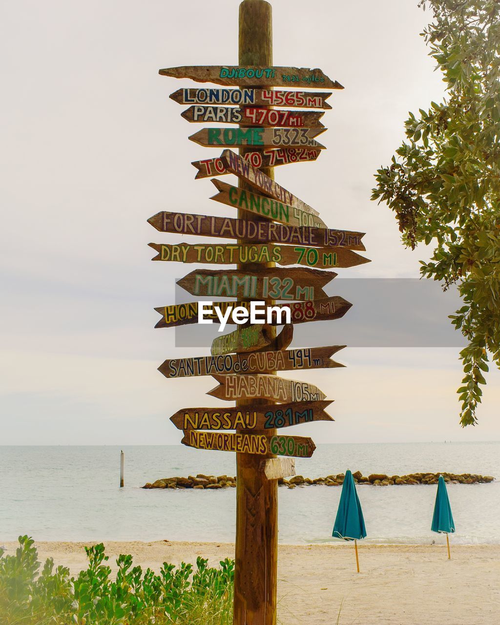 Sign on the beach against sky