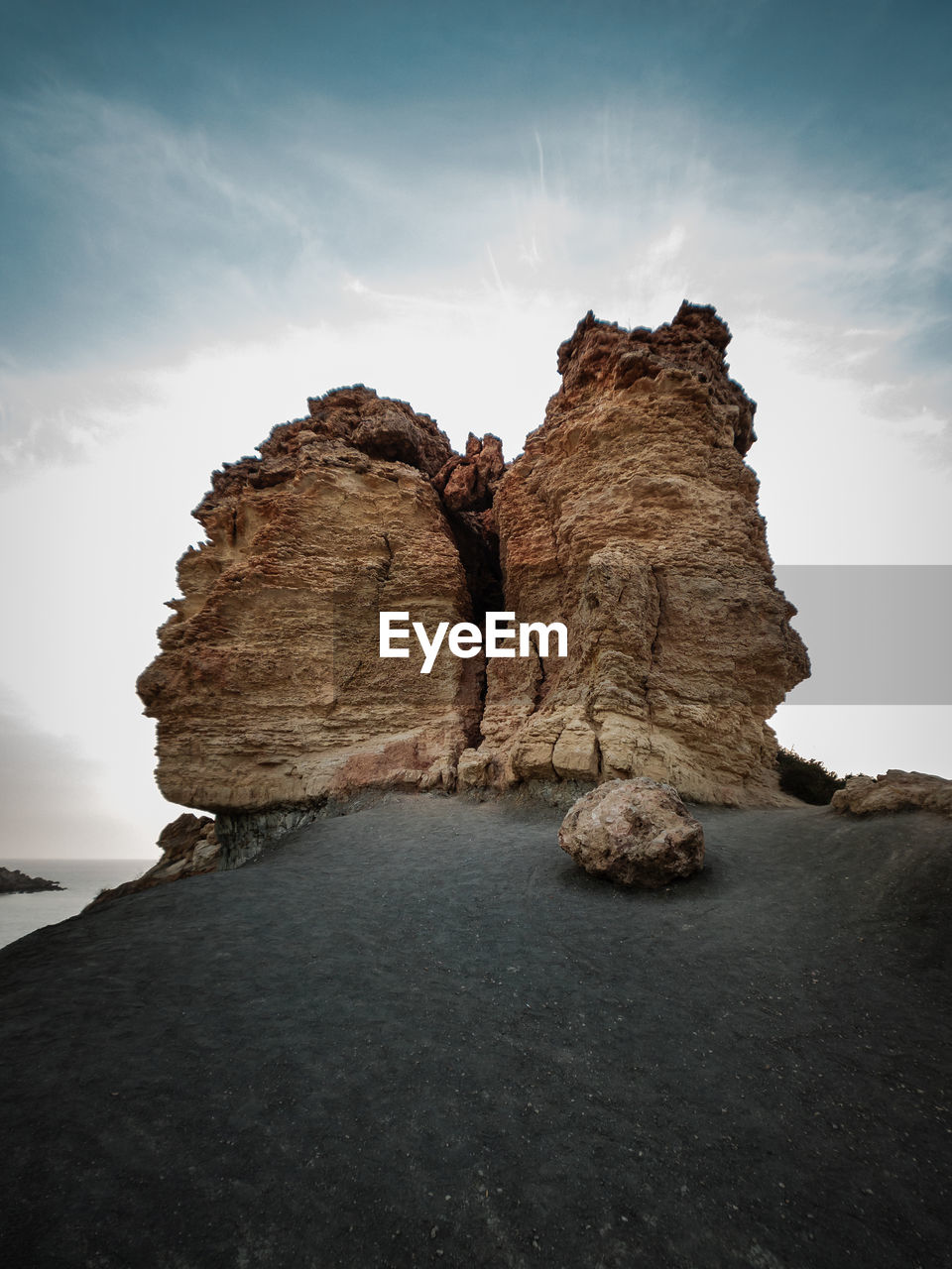 Rock formations by sea against sky