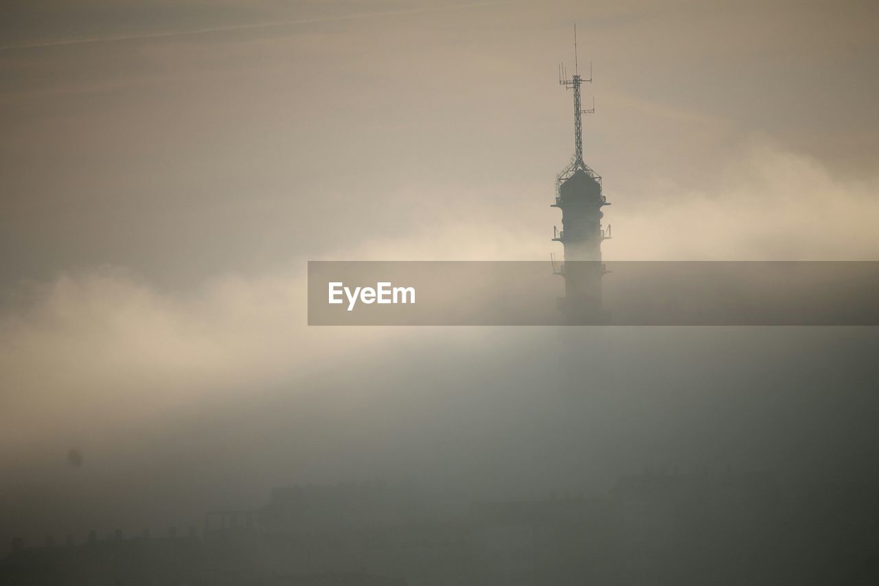 View of tower in clouds