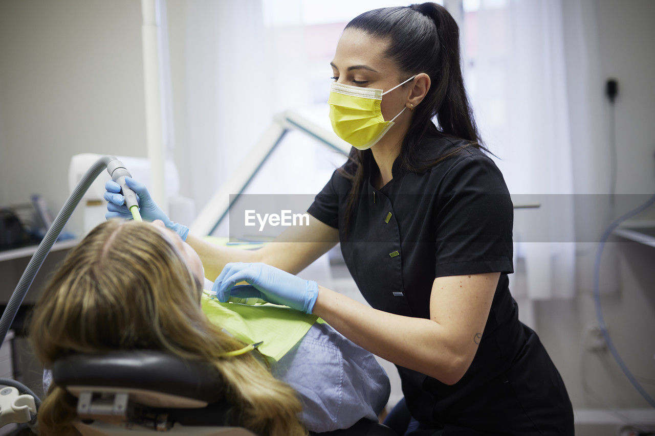 Female dentist with patient in office