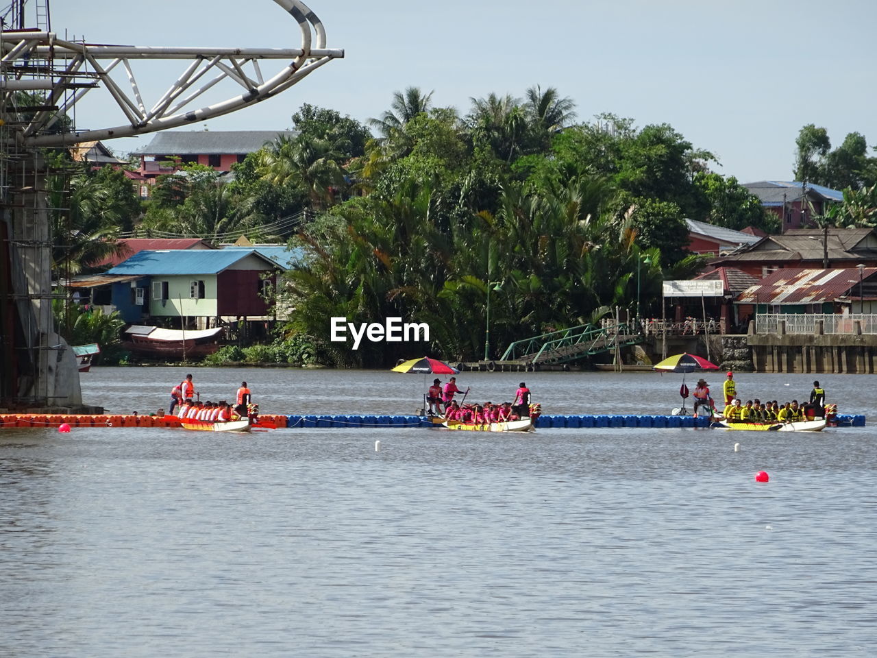 BOATS ON RIVER AGAINST TREES