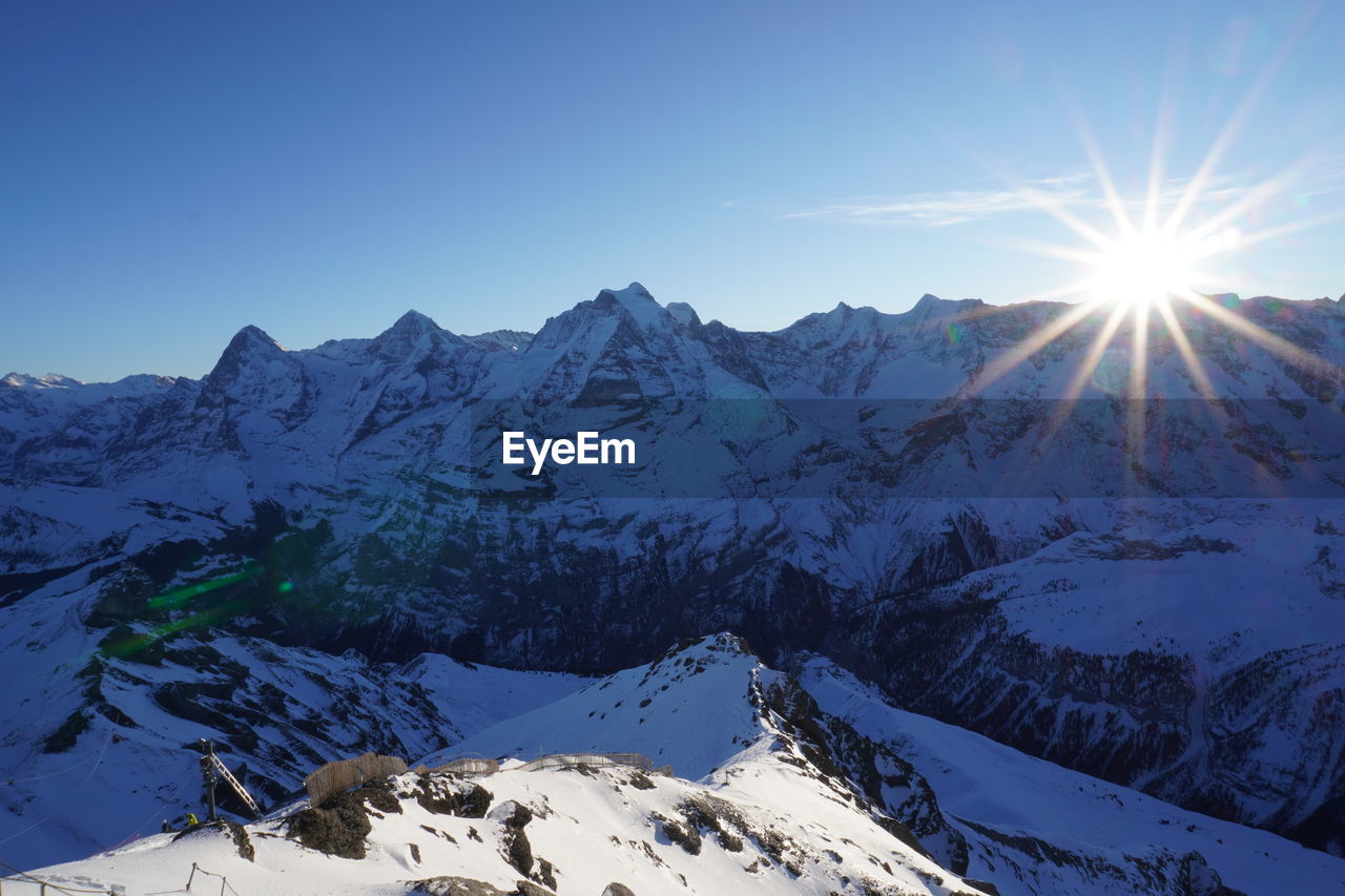 Scenic view of snowcapped mountains against clear sky