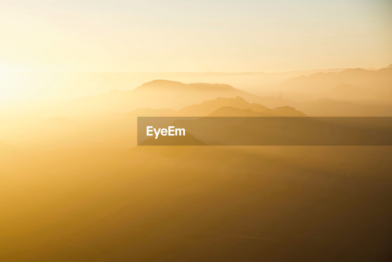 Scenic view of mountains against sky during sunset