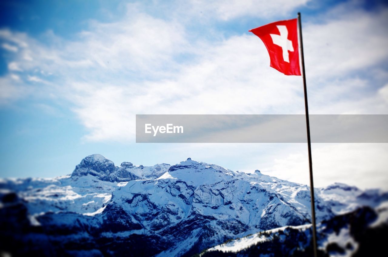 Swiss flag against snow mountain