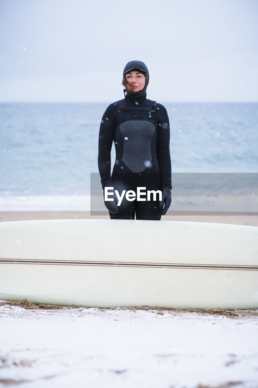 Young woman going winter surfing in snow